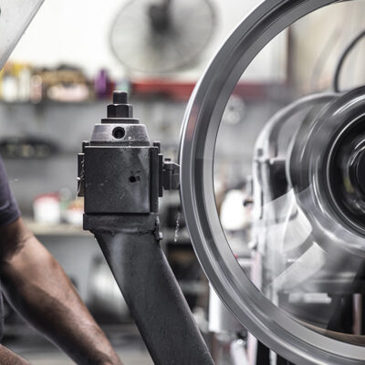 Technician preparing a wheel for refinishing