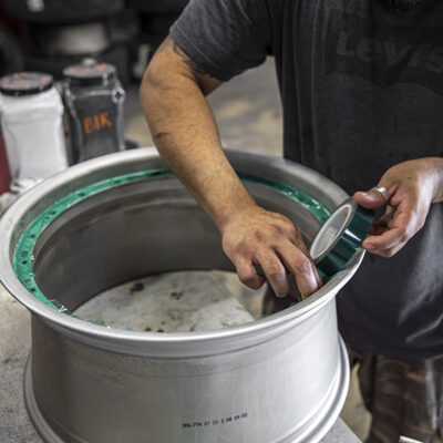 Technician repairing a damaged rim
